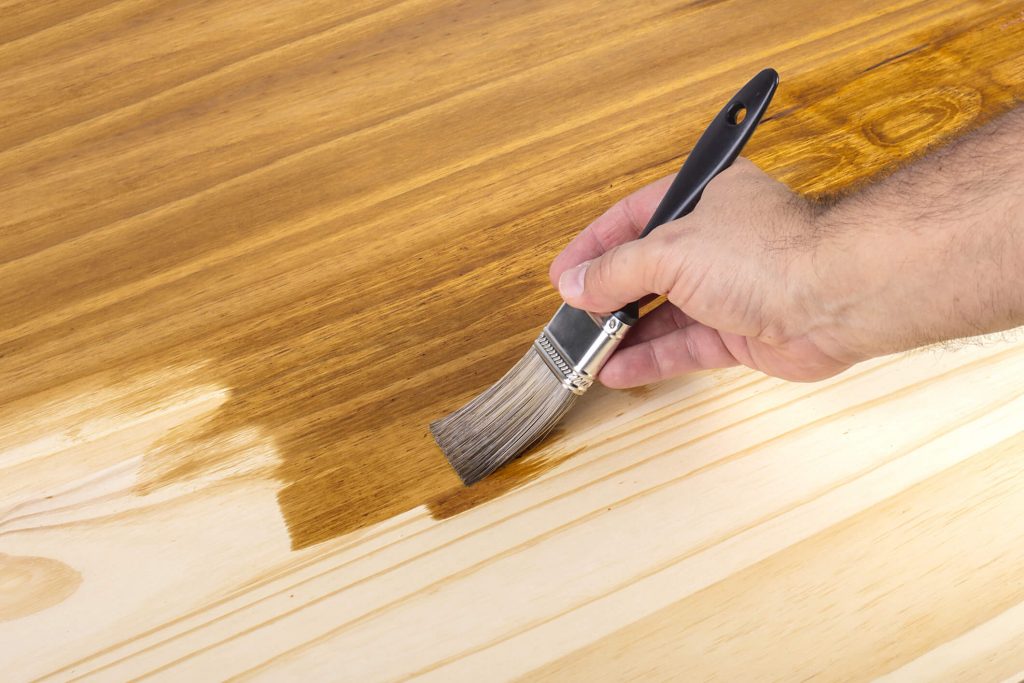 Wood stain being applied to a floor.